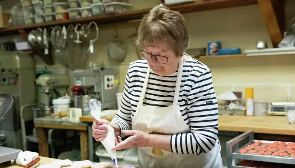 Karen Mitchell decorates iced sugar cookies at the original location of the Model Bakery on Main Street in St. Helena